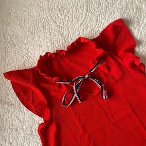 Red sleeveless blouse with ribbon tie